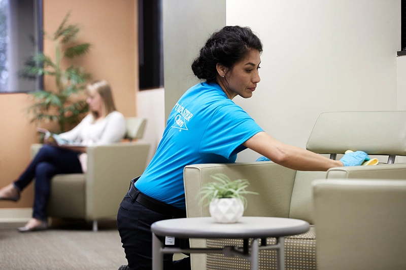 team member cleaning a resident lounge